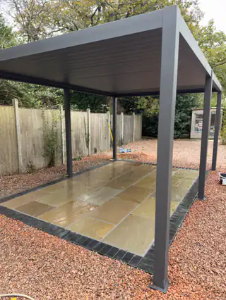 Stone patio beneath a garden pergola